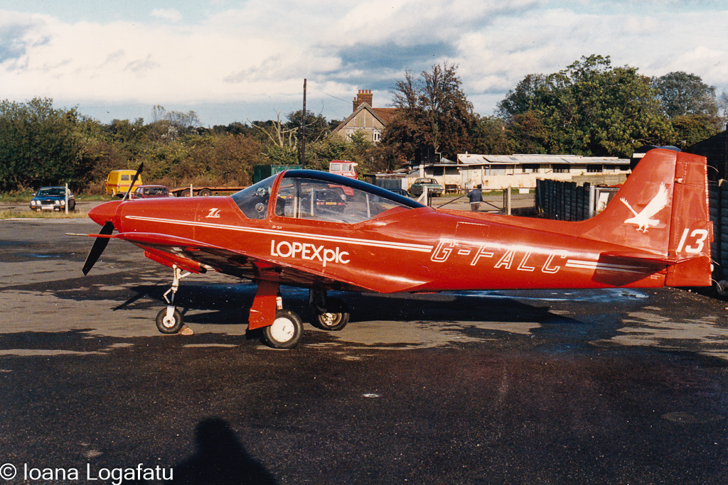 Vibrant red aircraft parked at serene airfield