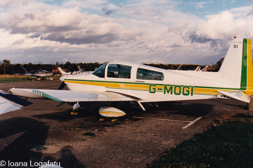 Vintage aircraft parked on a cloudy day