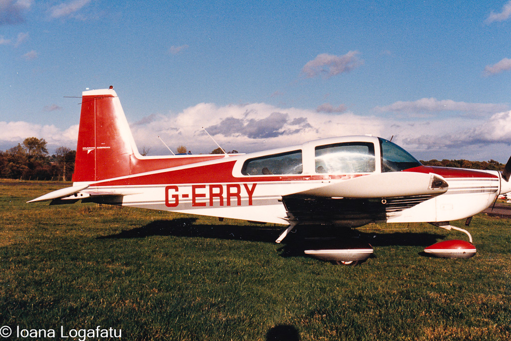 Vintage aircraft resting on a grassy runway