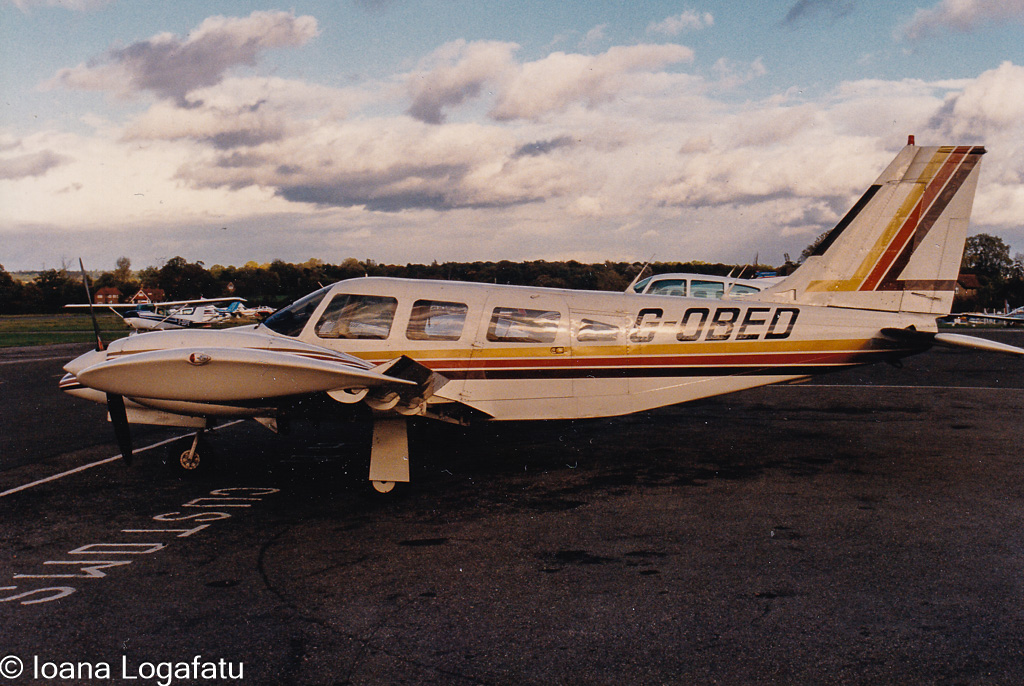 Vintage airplane parked on a runway during sunset
