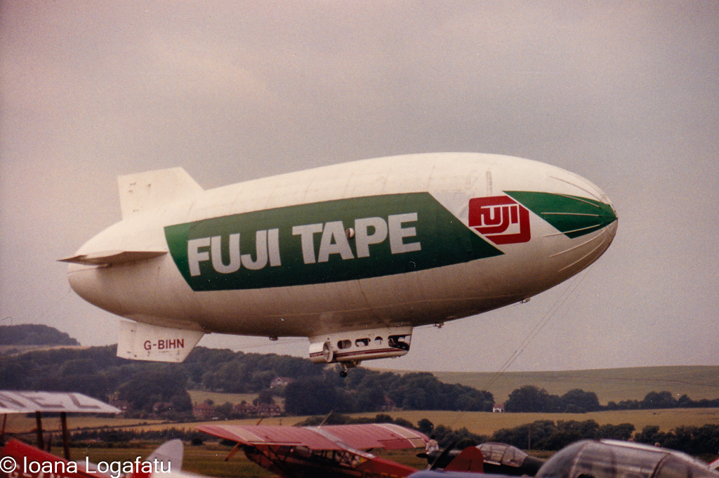 Blimp gracefully soaring over a vintage airfield