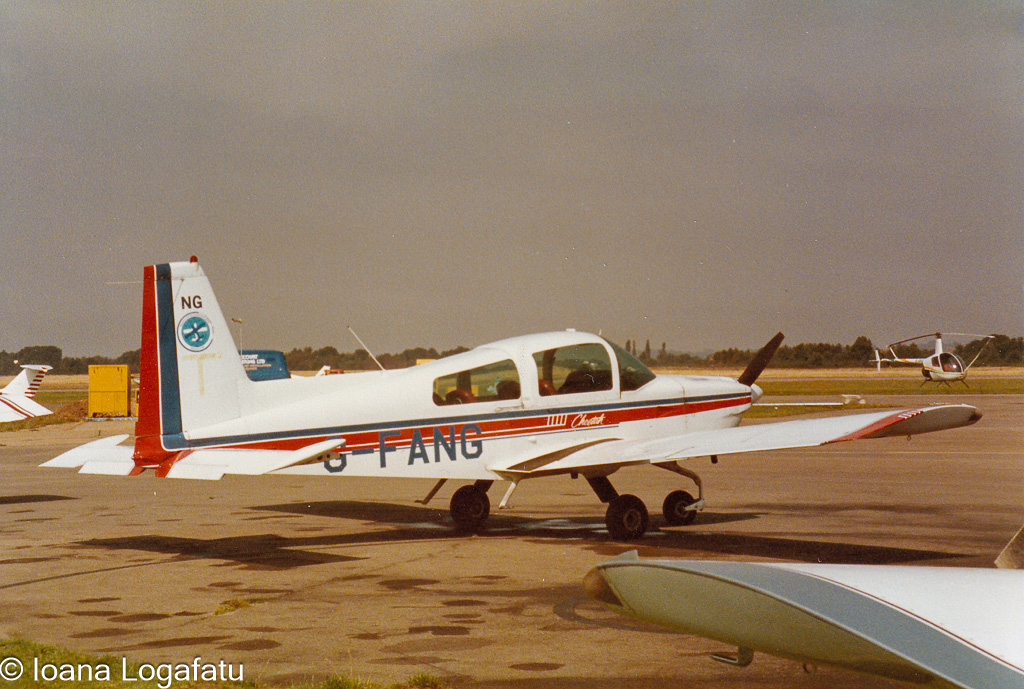 Vintage aircraft at a sunny airfield on a calm day