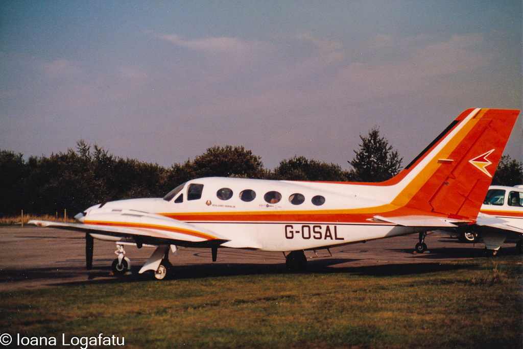Vintage aircraft parked on the runway at dusk
