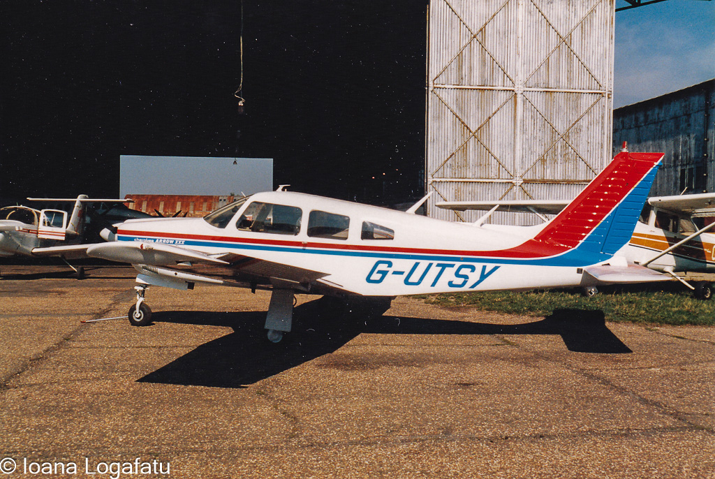 Classic aircraft parked at a small airfield