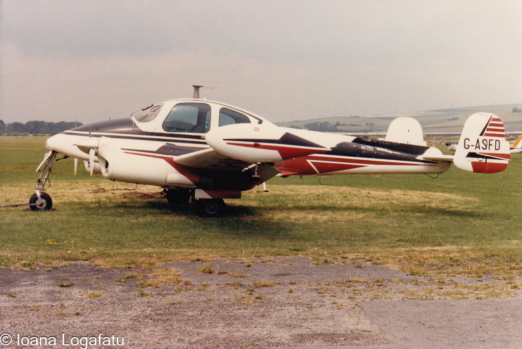 Vintage aircraft parked on a grassy airfield
