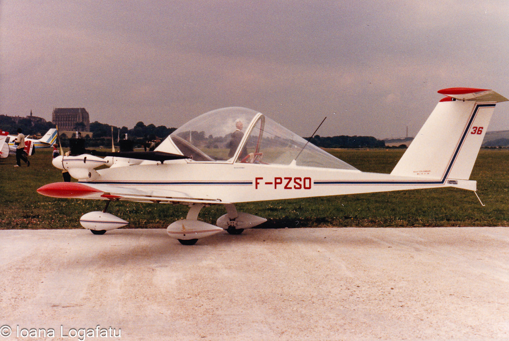 Vintage light aircraft parked on a grassy airfield