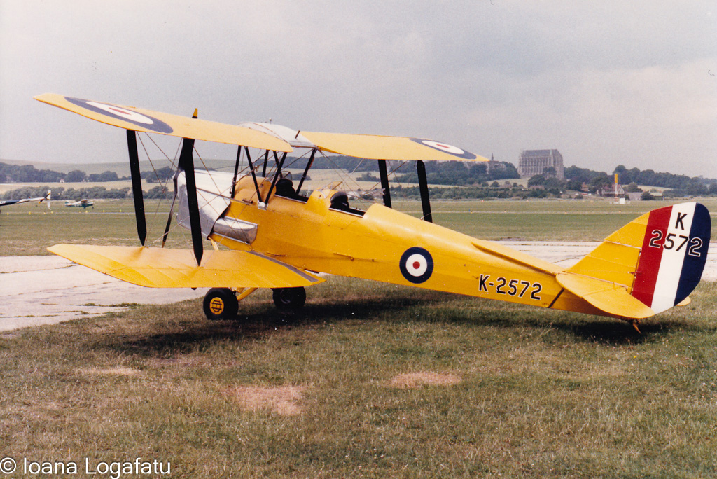 Biplane at a calm, cloudy airfield