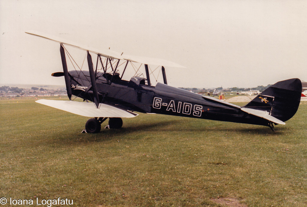 Classic biplane showcased on a sunny airfield day