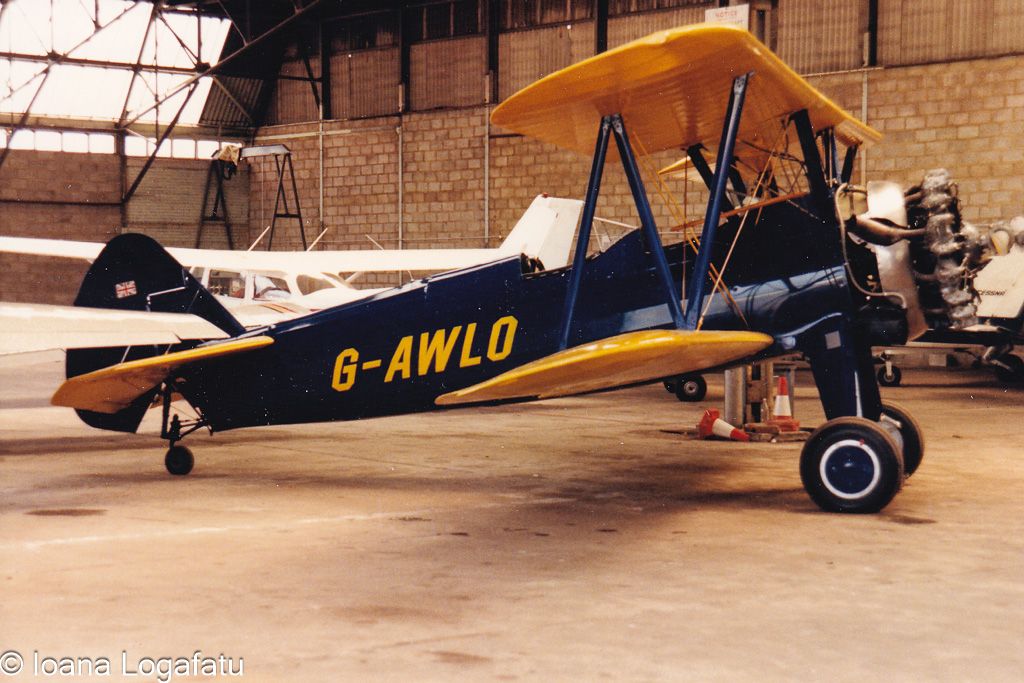 Vintage biplane on display in an aviation hangar