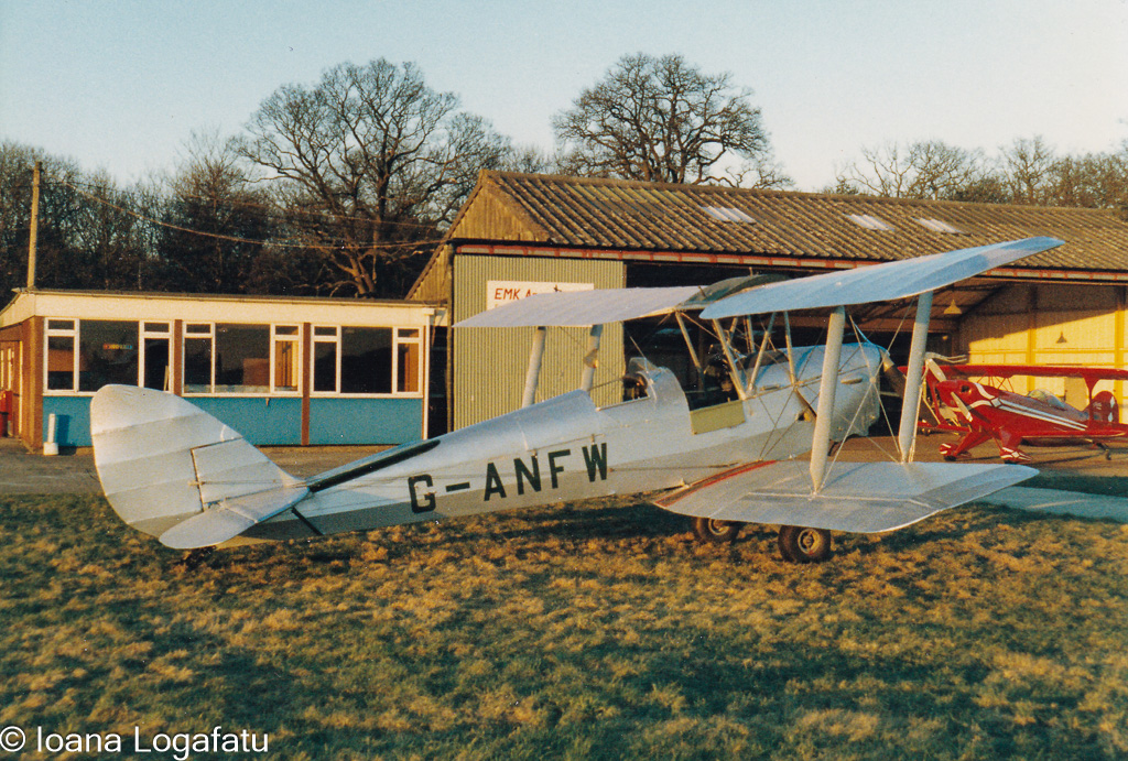 Biplane at airfield at sunset