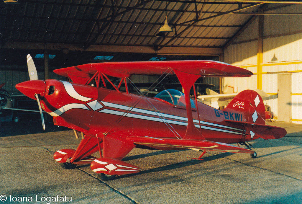 Biplane rests in bright hangar after flight