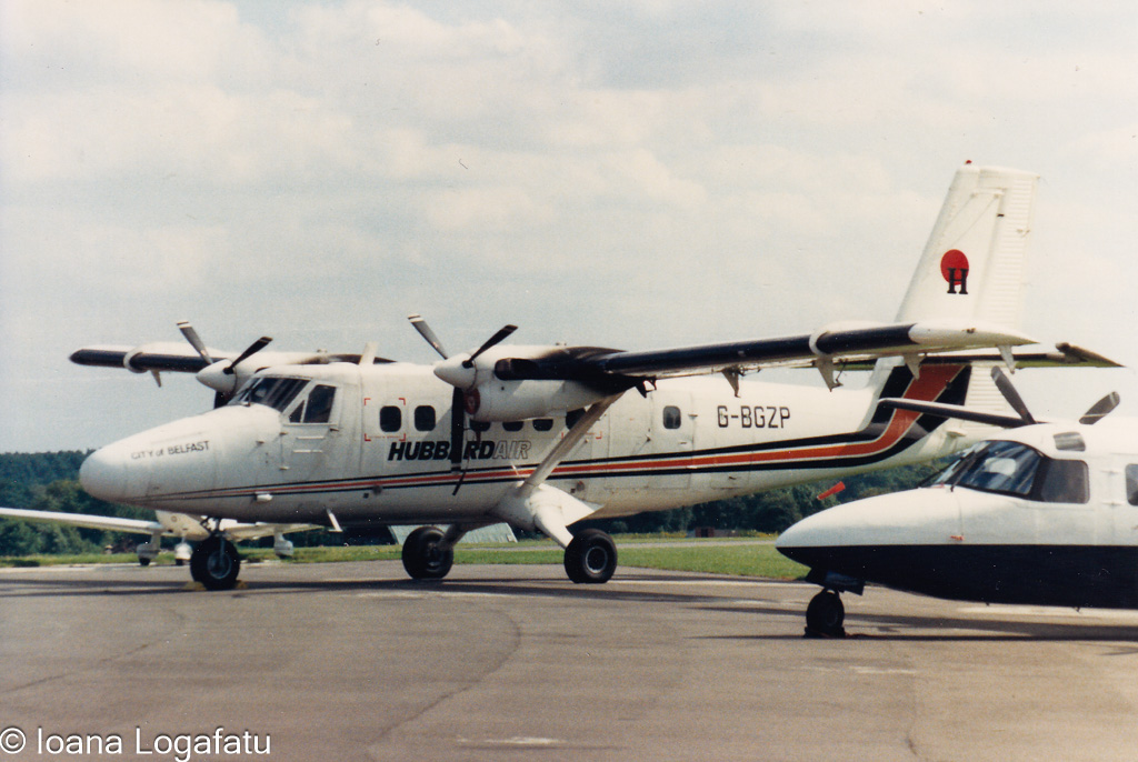 Vintage aircraft on tarmac during sunny day