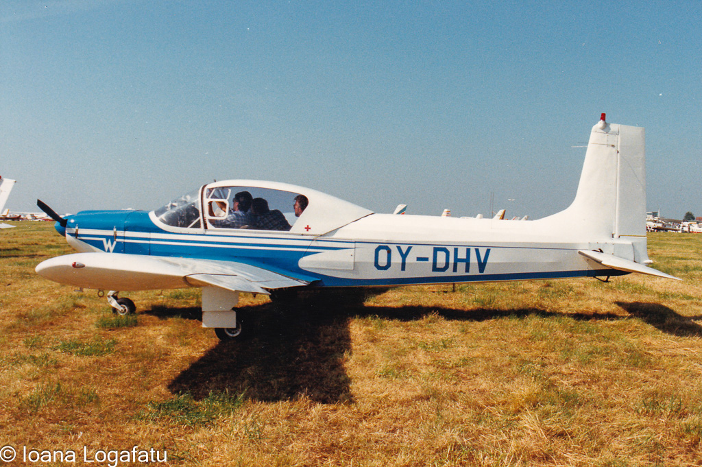 Vintage aircraft parked on a grassy airfield
