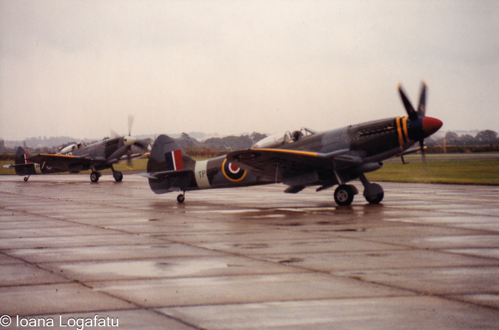 Historic fighters taxiing on a rainy airfield