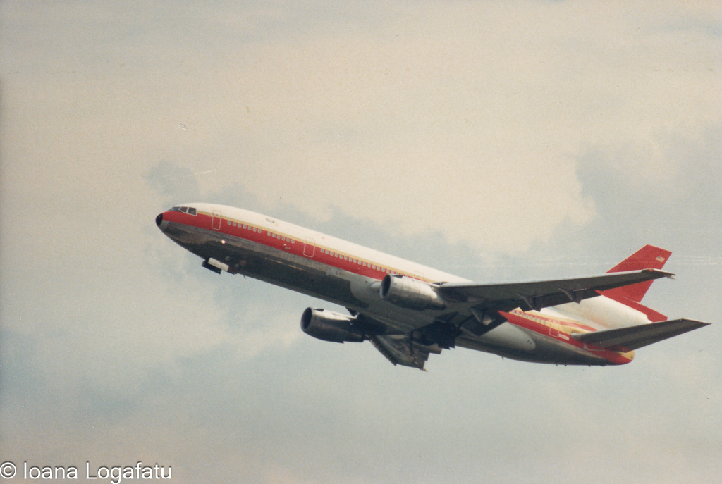 Vintage aircraft soaring above a cloudy sky