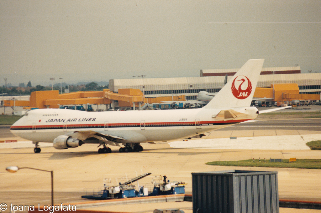 Japan Airlines jet taxiing at a busy airport