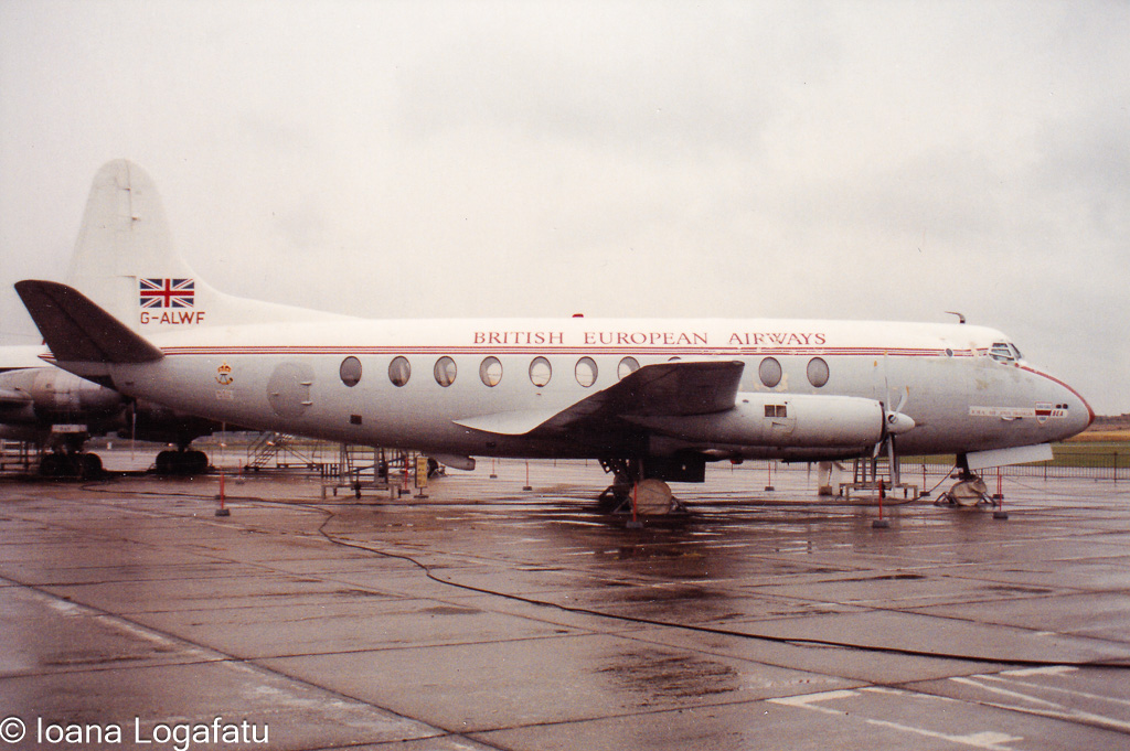 Vintage aircraft perched on a rainy airport tarmac