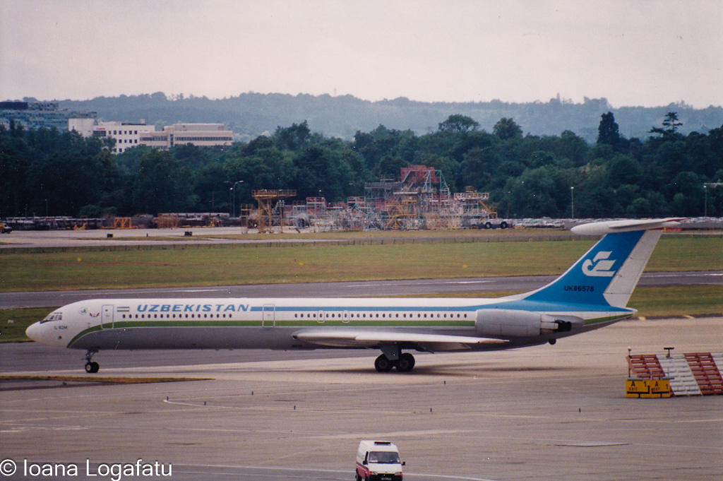 Uzbekistan Airlines jet on the runway at dusk