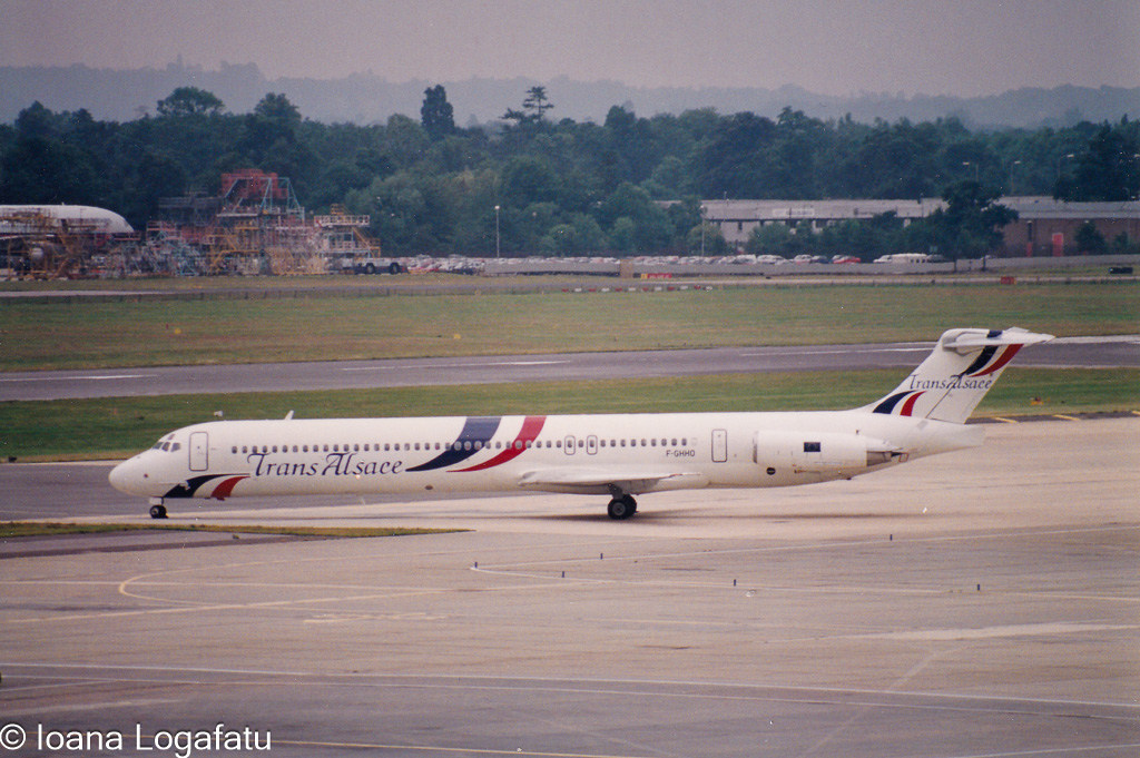 Jet flying high over busy airport