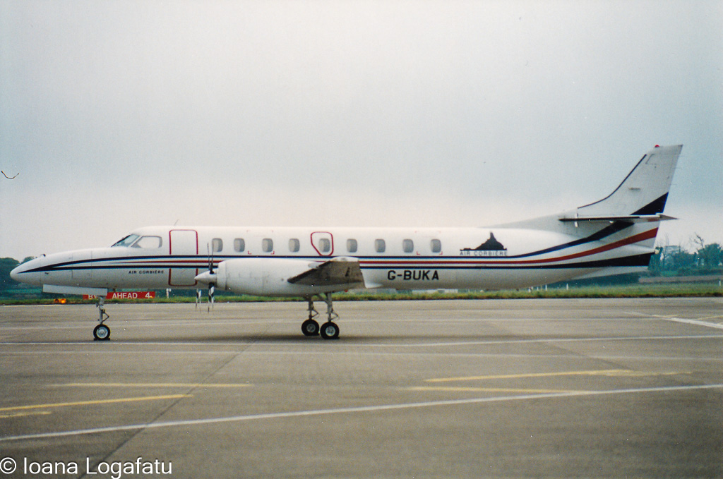 Vintage aircraft parked on runway at airport