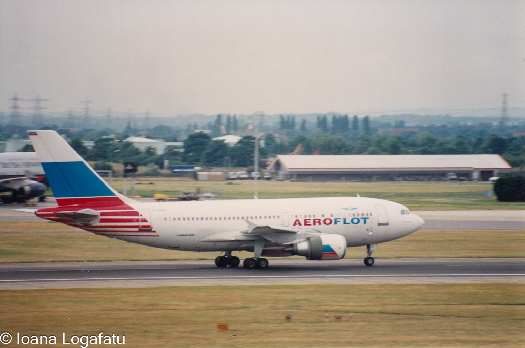 Jet in motion on a runway under cloudy skies
