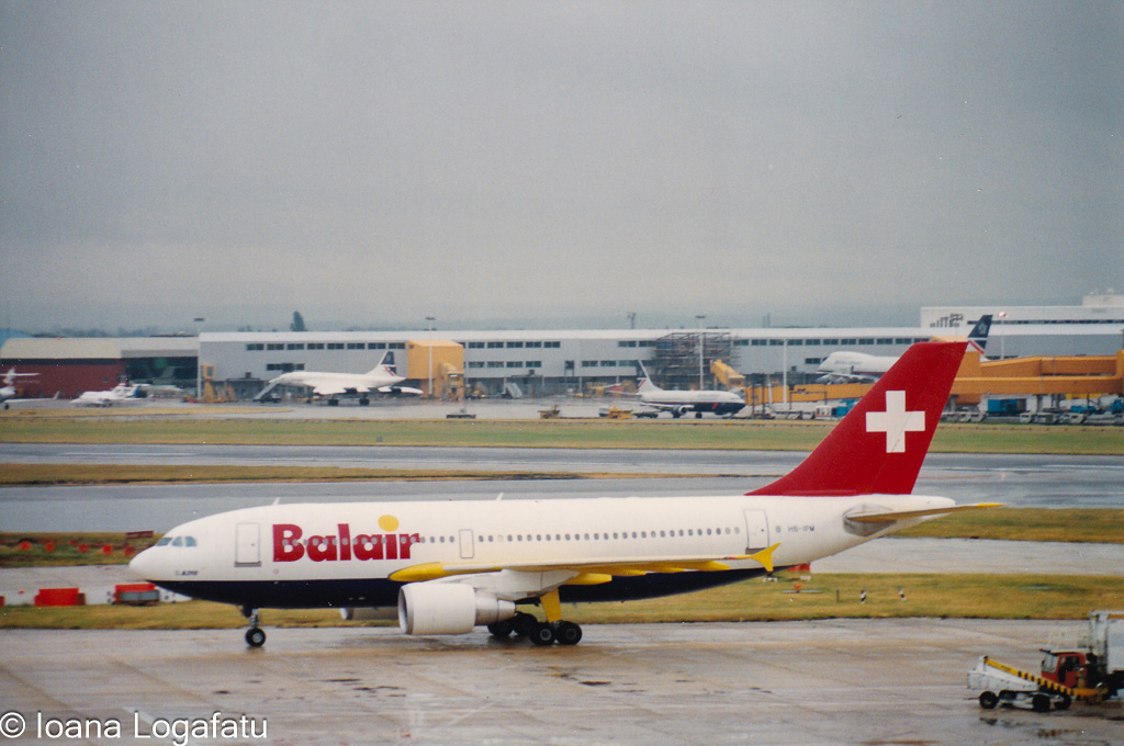 Plane taxiing under gray skies