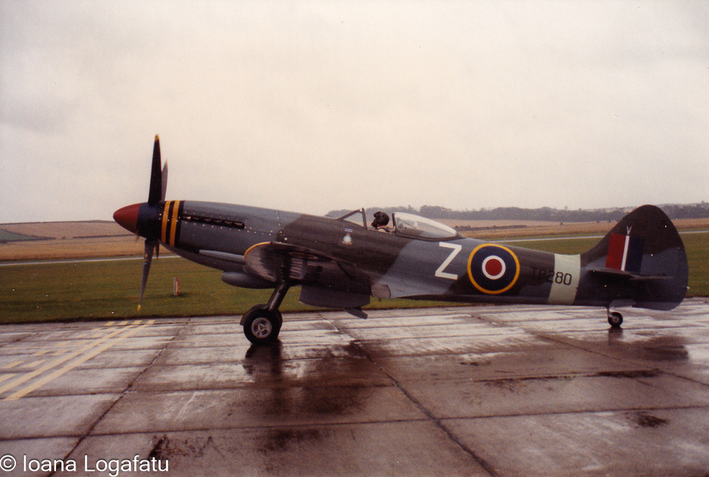 Historic aircraft at a rainy airfield