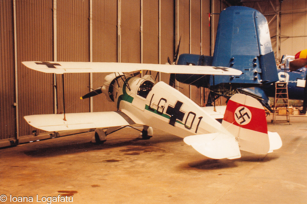 Vintage aircraft displayed in an aviation hangar