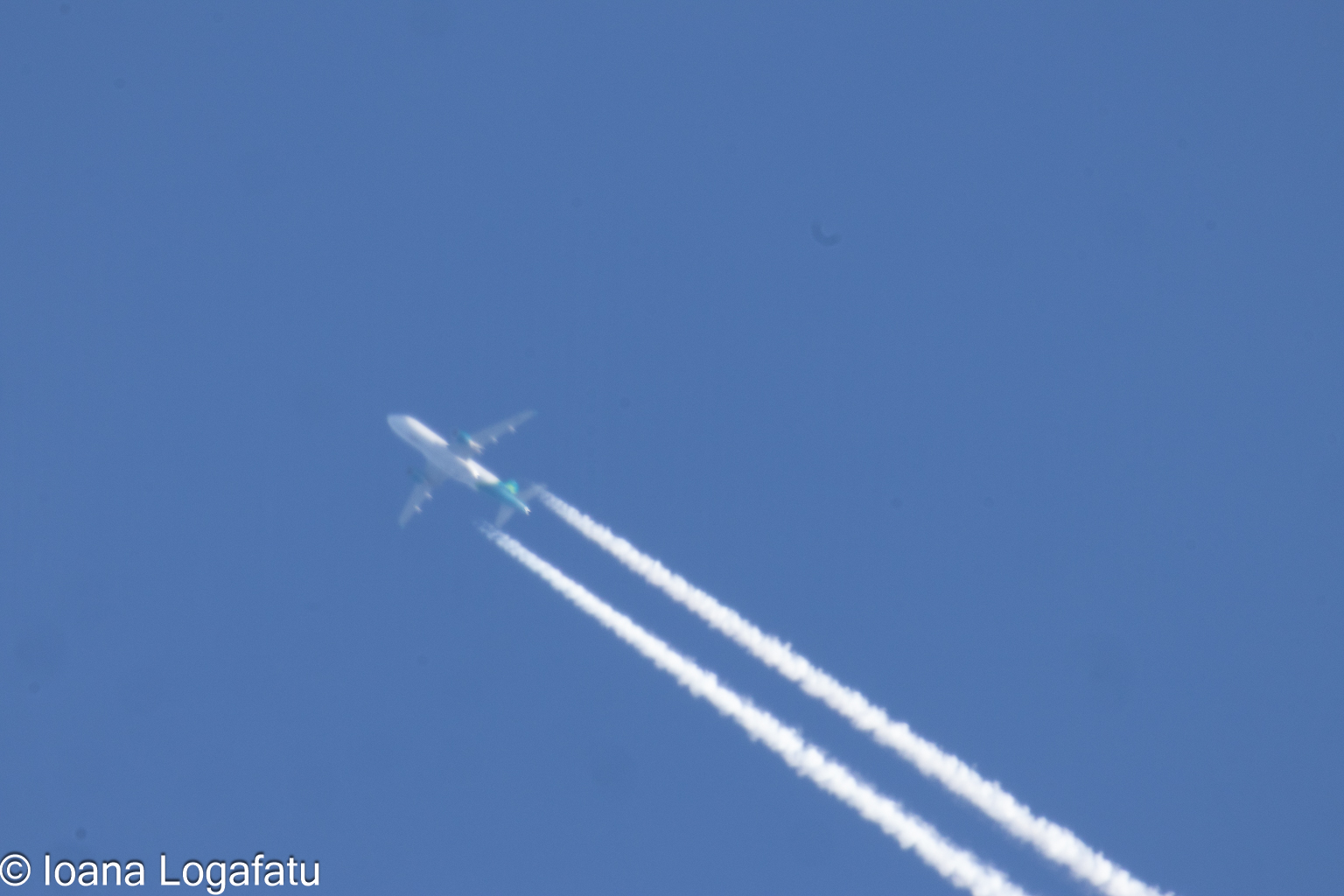 Airplane gliding through clear blue skies