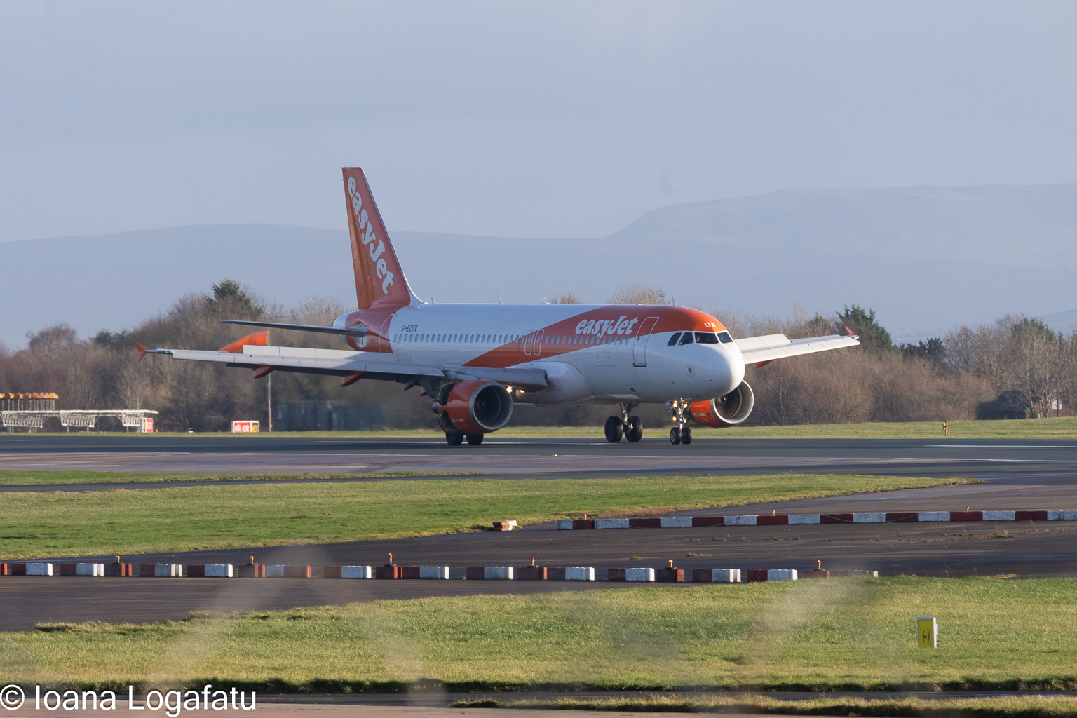 EasyJet aircraft preparing for takeoff at sunset