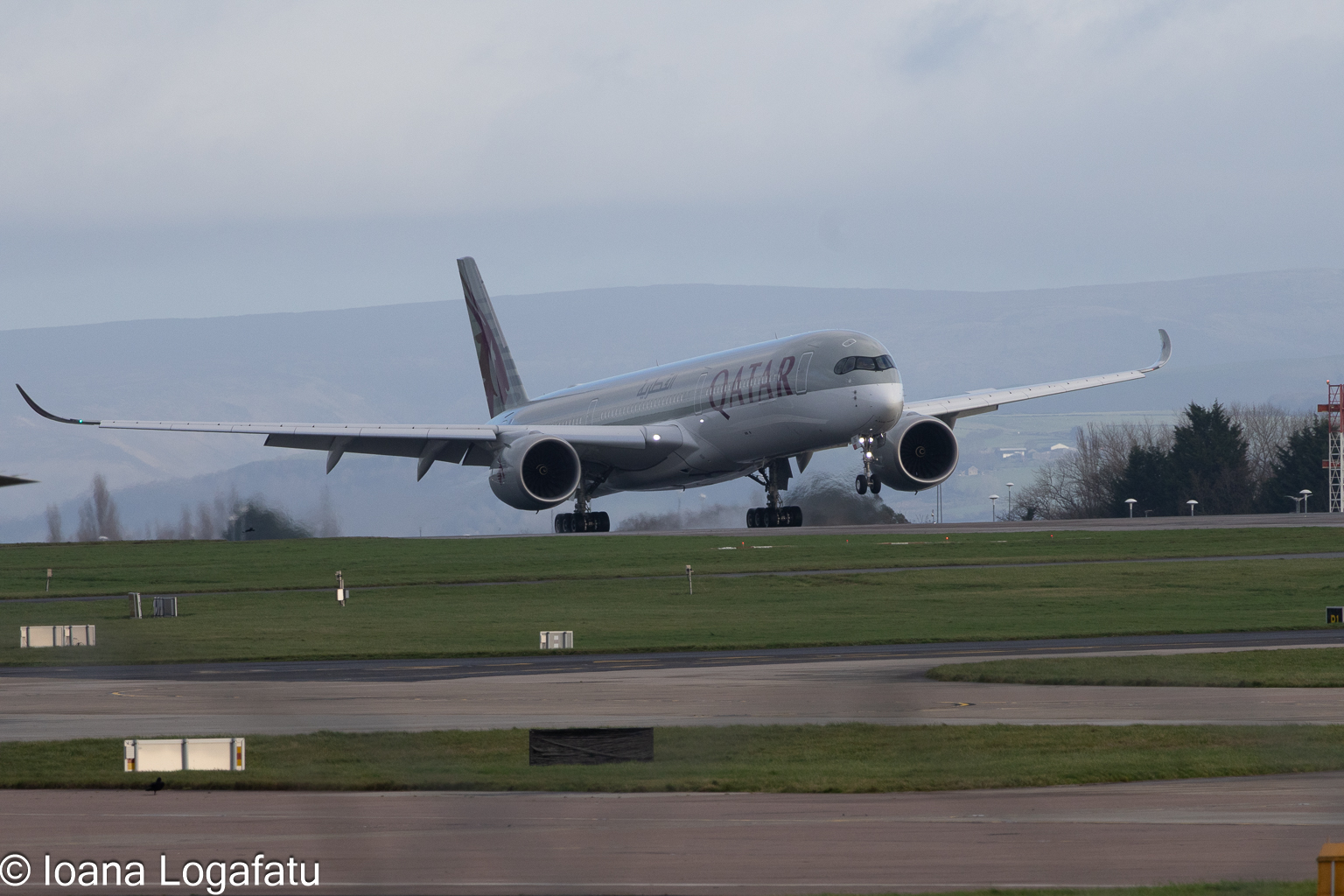Plane takes off at a busy airport on a cloudy day