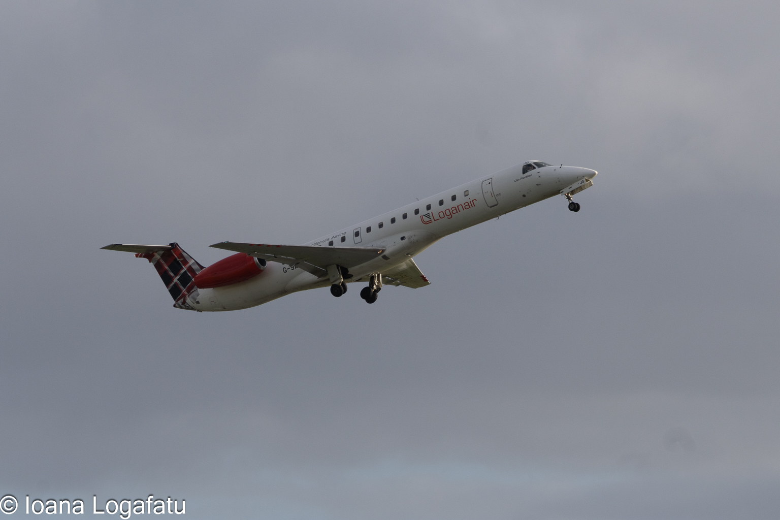 Airplane soars high into the cloudy sky
