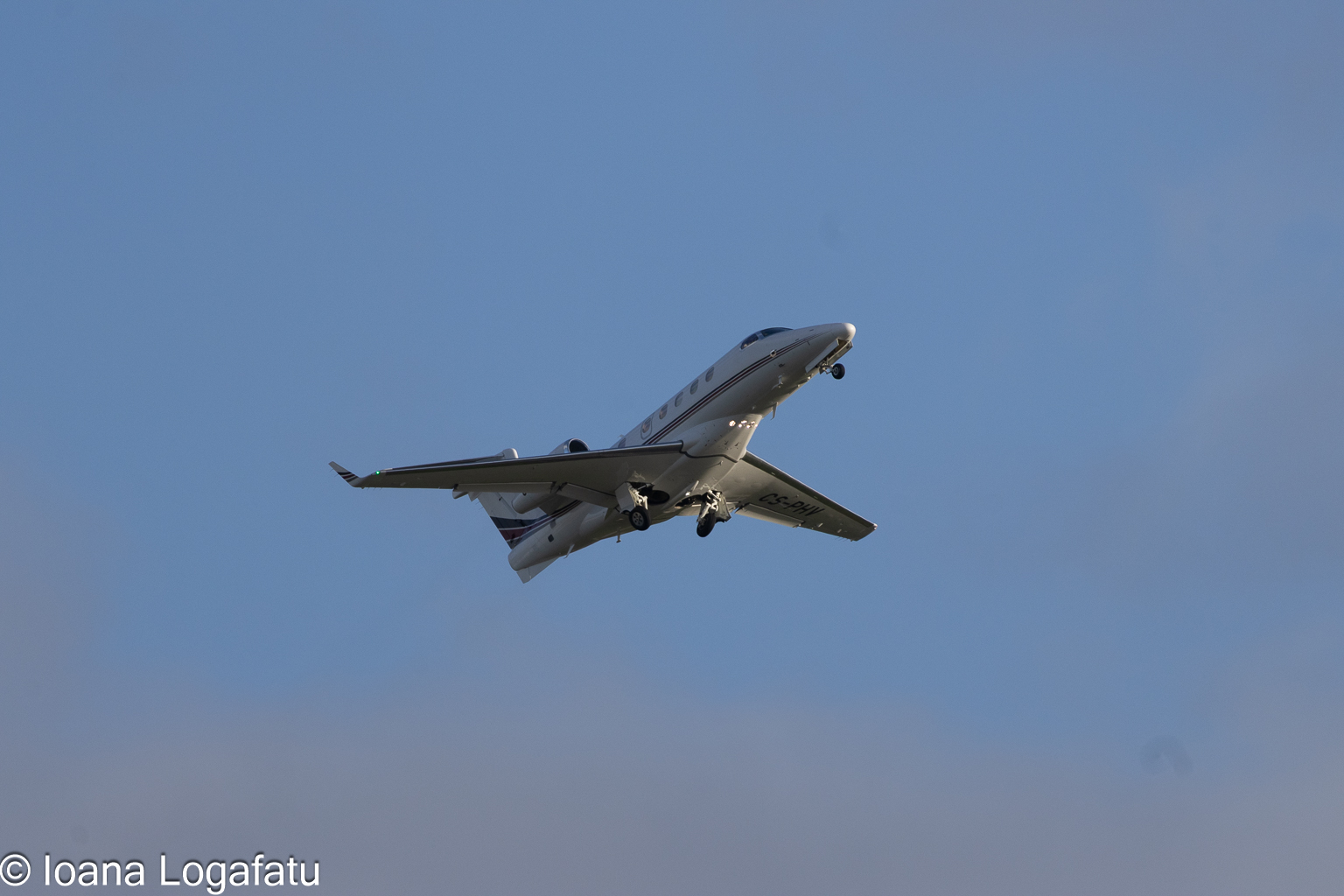 Stylish private jet soaring through a clear sky