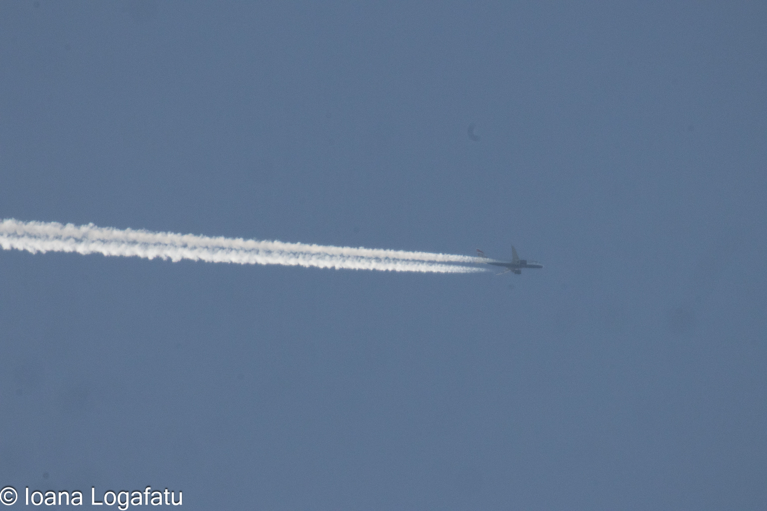 Airplane soaring through a clear blue sky