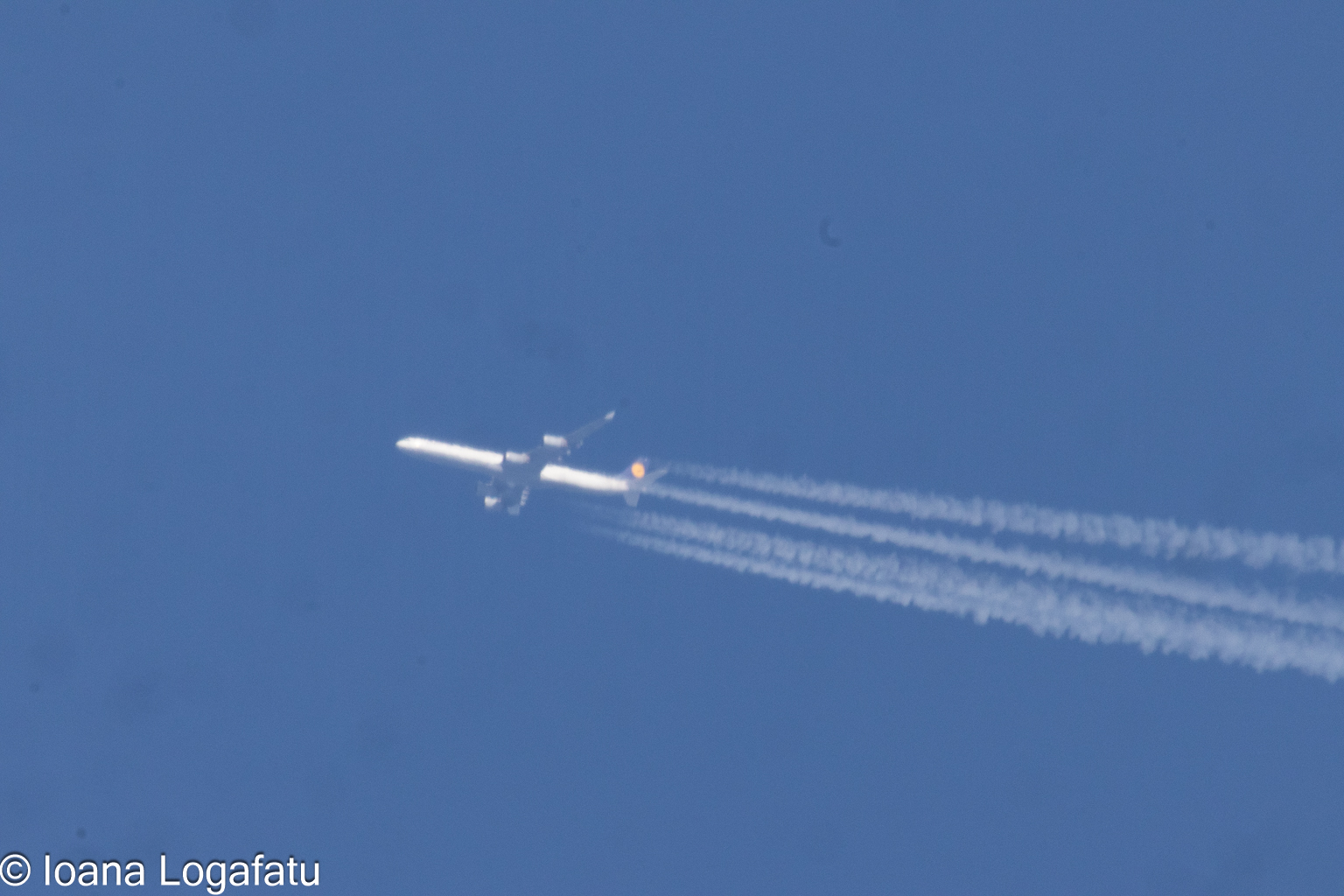 High above the clouds, an airplane glides smoothly