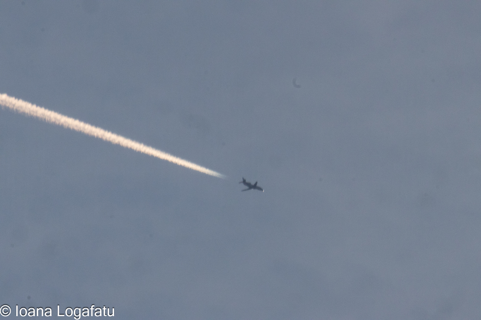 Jet soaring high with a streak in the sky