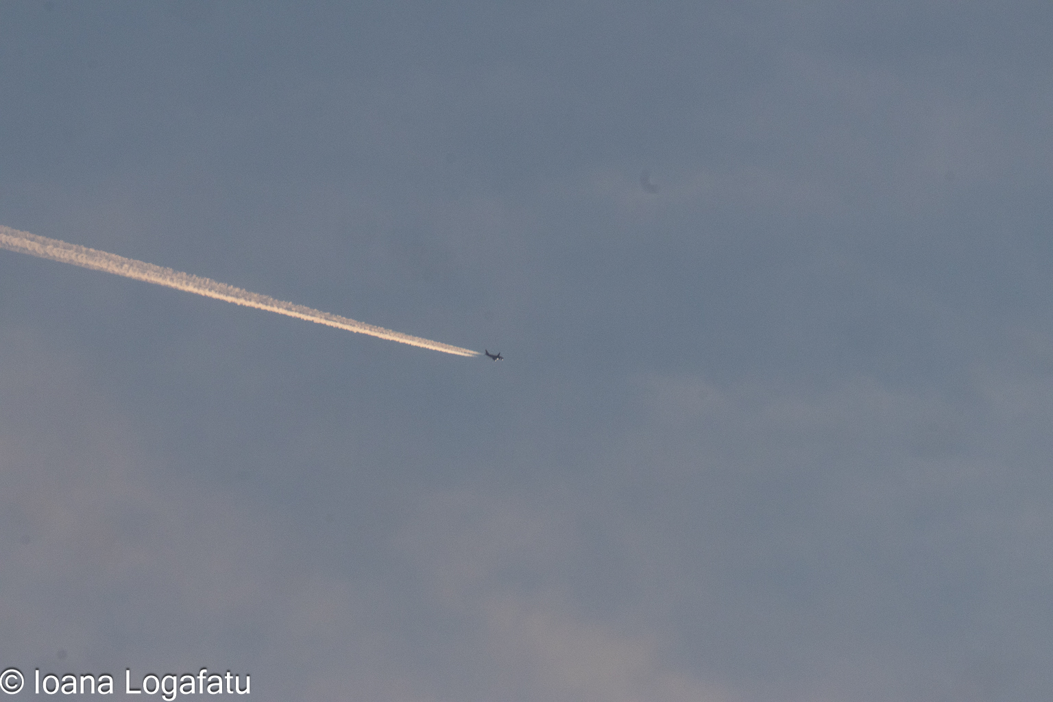 Jet leaving a trail in the blue sky above