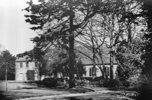 Historic building surrounded by large trees