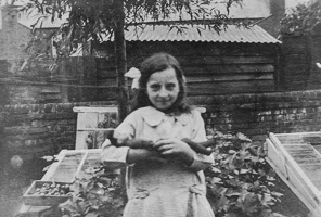 Girl holding vegetables in garden during summer