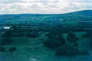 Expansive green hills under a cloudy sky