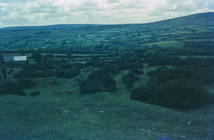 Rolling green hills under a cloudy sky