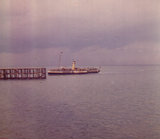 Boat cruising near the pier on a cloudy day