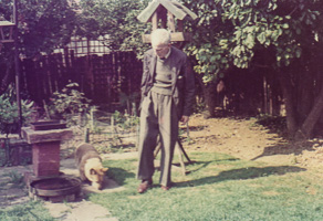 Man with dog in a garden during a sunny day