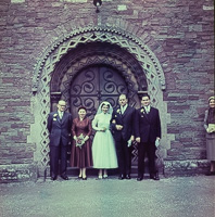 Wedding party standing outside historic venue