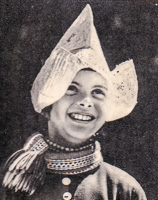 Child smiling with traditional hat and attire