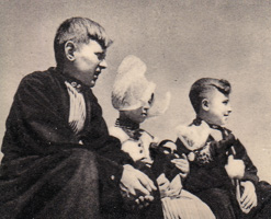 Children seated outdoors enjoying a sunny day