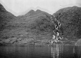 Serene mountain landscape with cascading waterfall