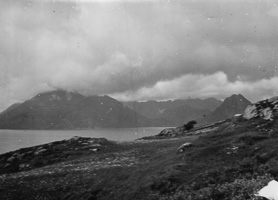 Coastal view with mountains and cloudy sky
