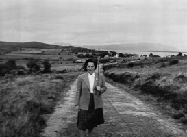 Woman walking along a country road in Ireland