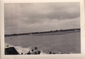 Sailing along the calm waters under gray skies